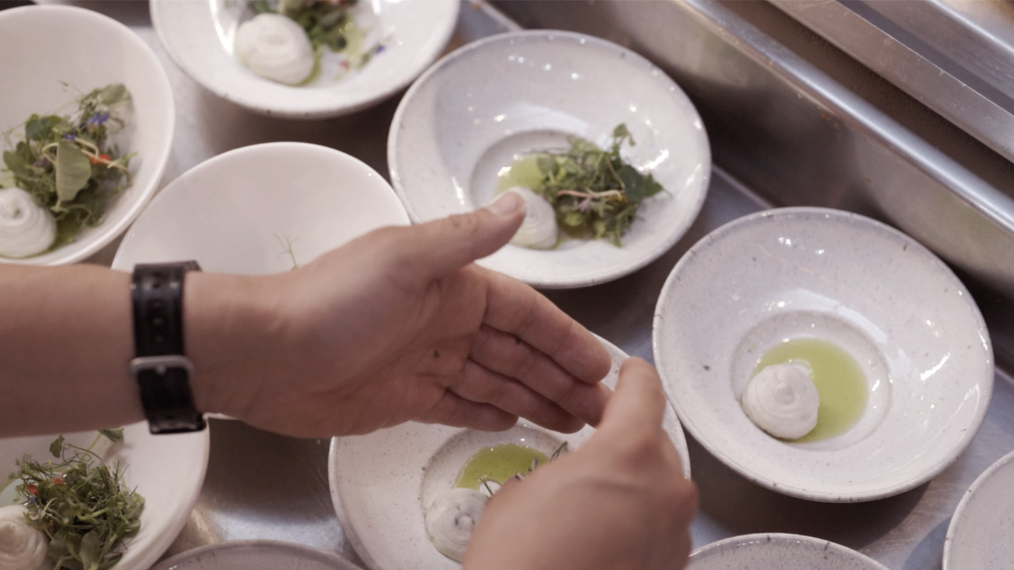 Hands over plates of food