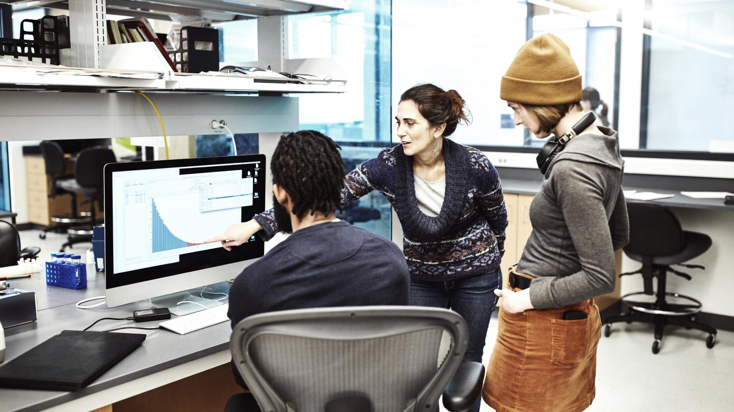 3 people looking at a monitor screen