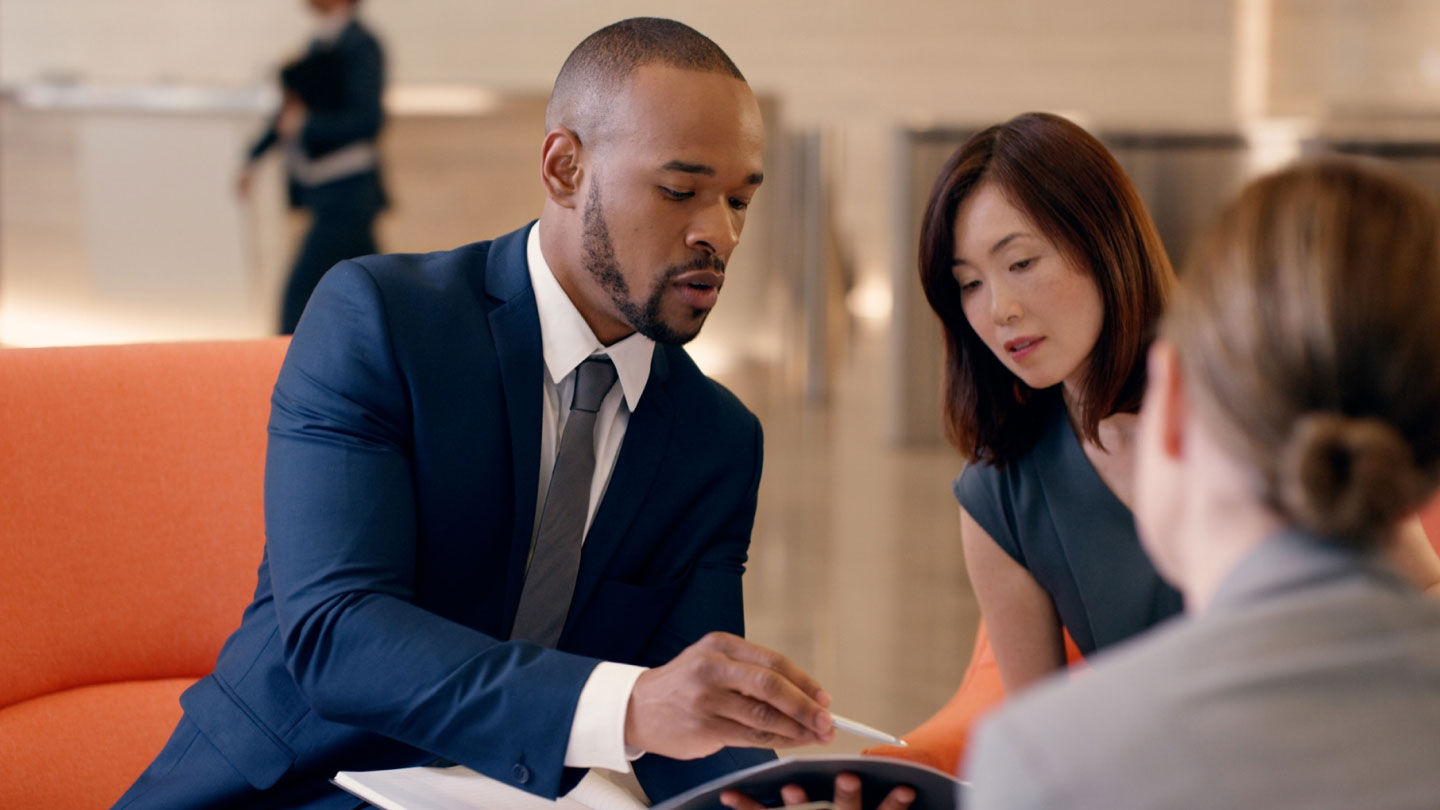 Professionals consulting a pamphlet