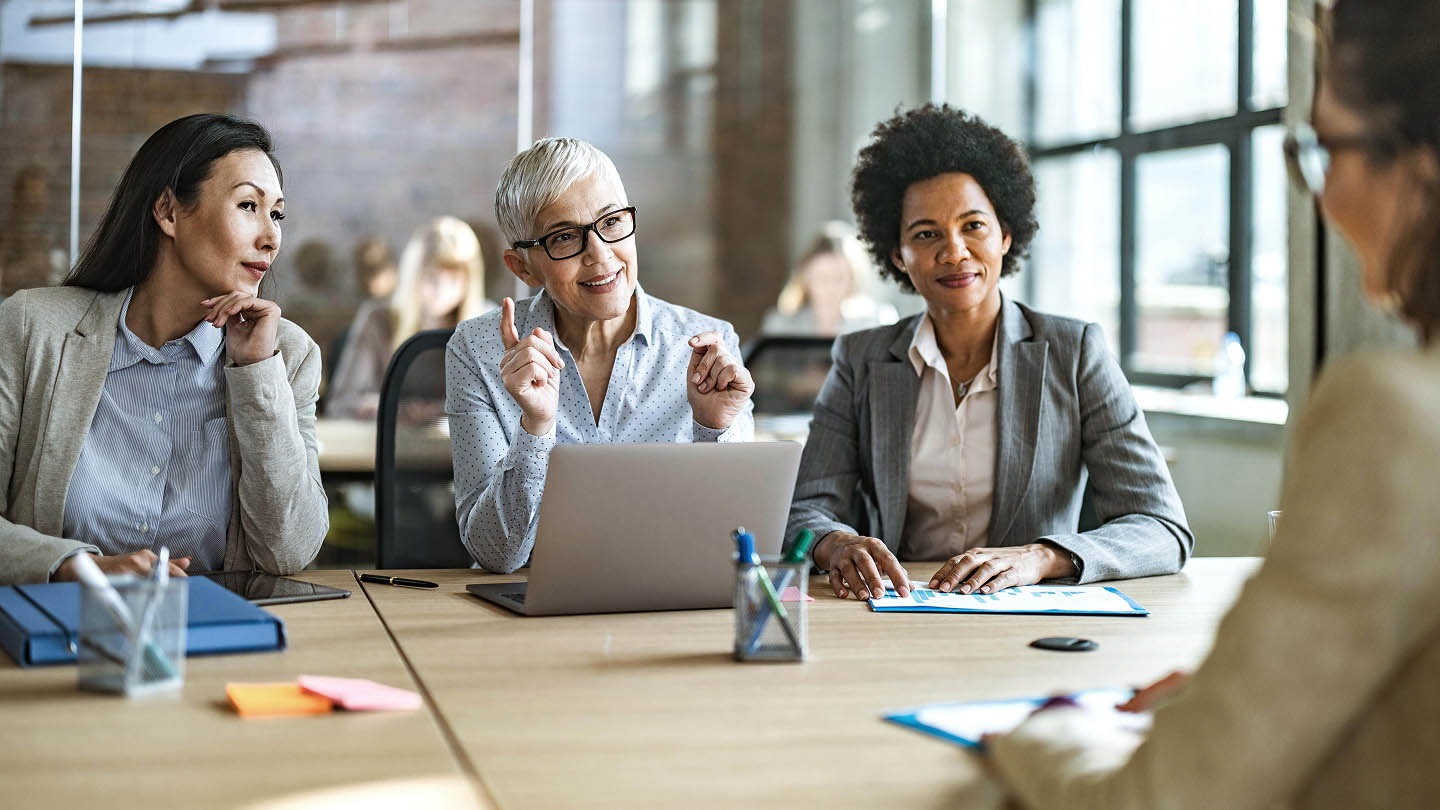 4 women in a meeting banner