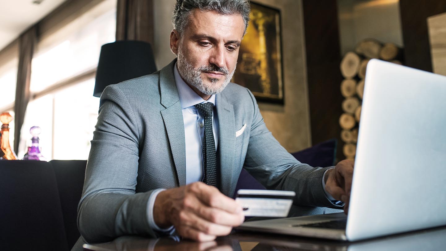 Man at computer with credit card