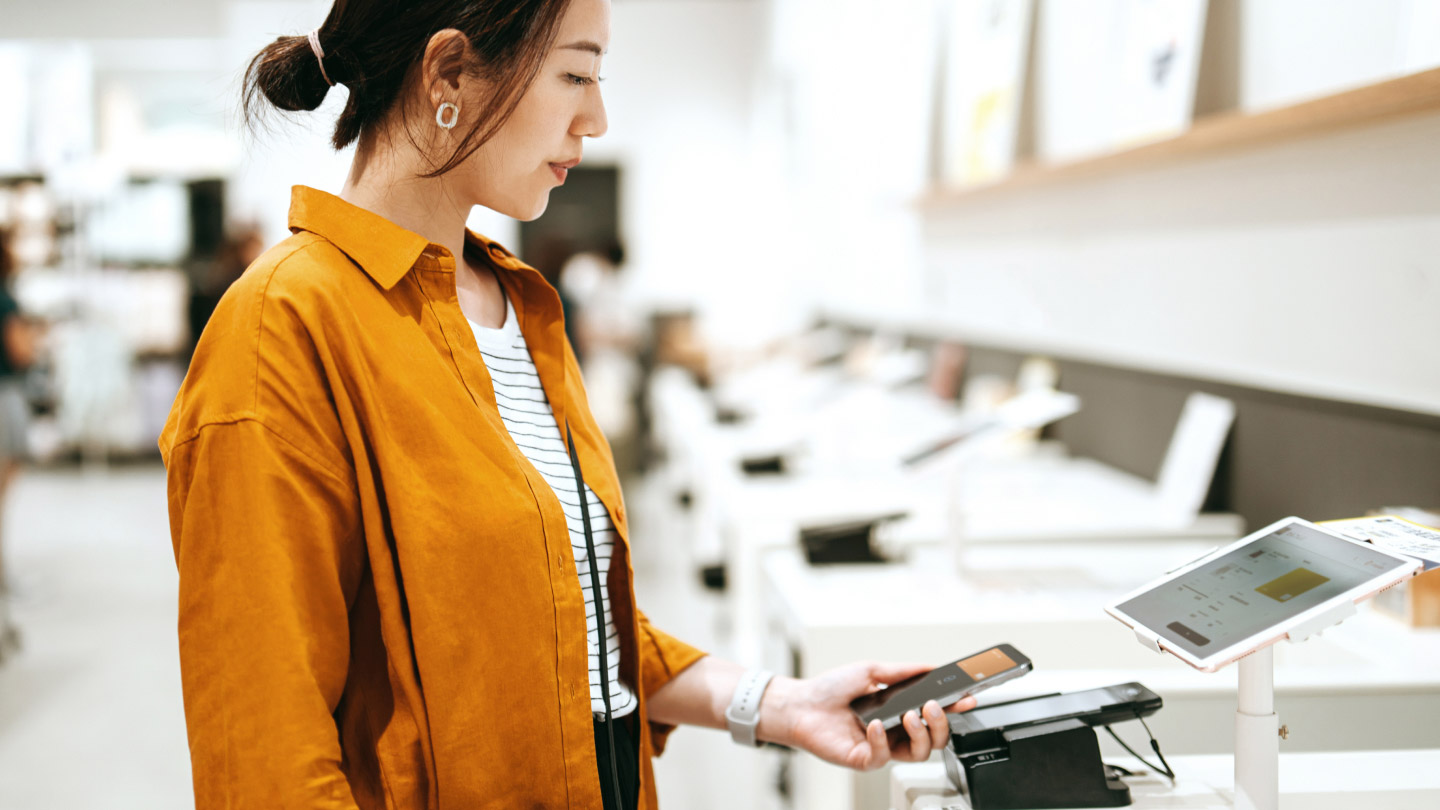 woman using phone to make payment banner