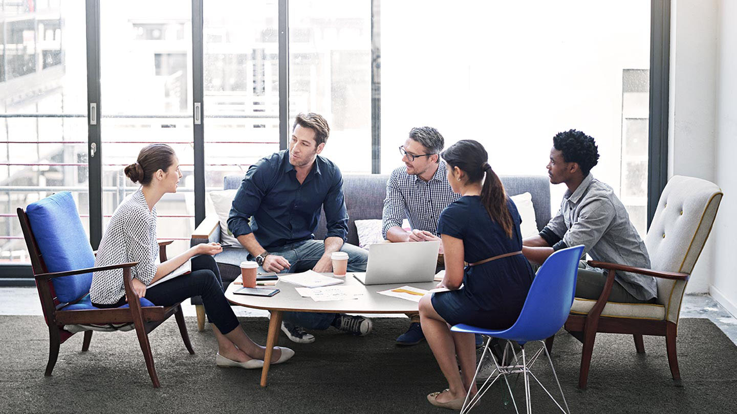 Group of five people meeting in an office 