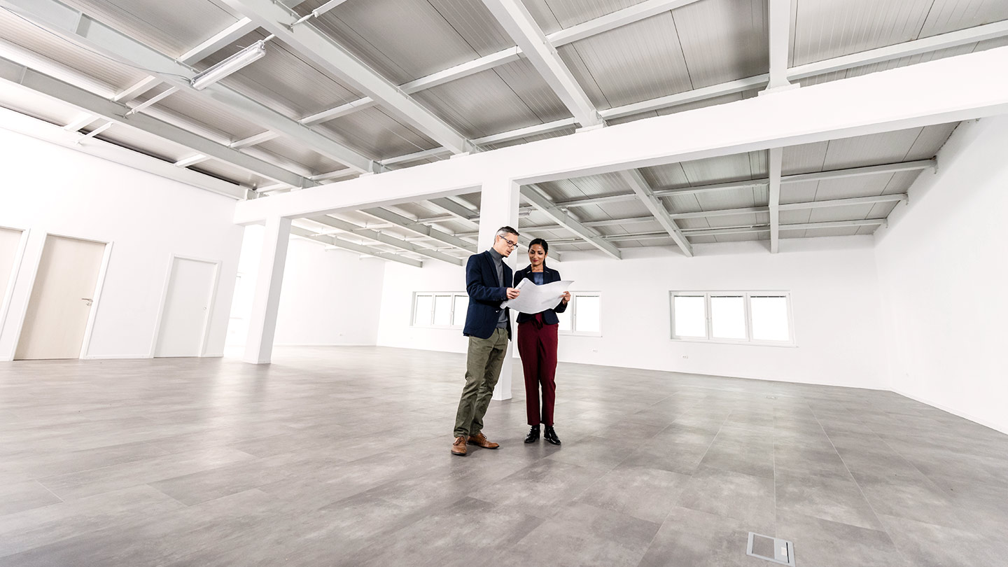 Two men in empty office space