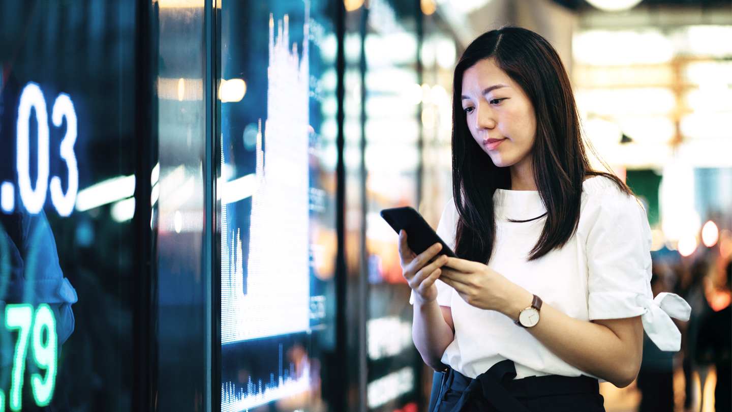 young woman looking at her phone banner