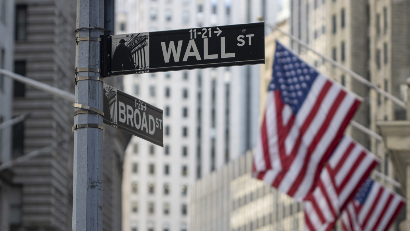 New York, NY, USA - July 4, 2022: The Wall Street sign is seen outside the New York Stock Exchange (NYSE) Building in the Financial District of Lower Manhattan in New York City.