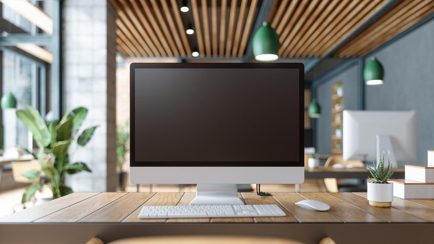 Blank Screen Computer On Table With Office In The Background