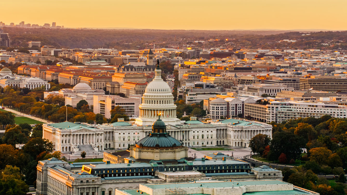 Helicopter shot of Capitol Hill in Washington, D.C. at sunset on a fall evening.