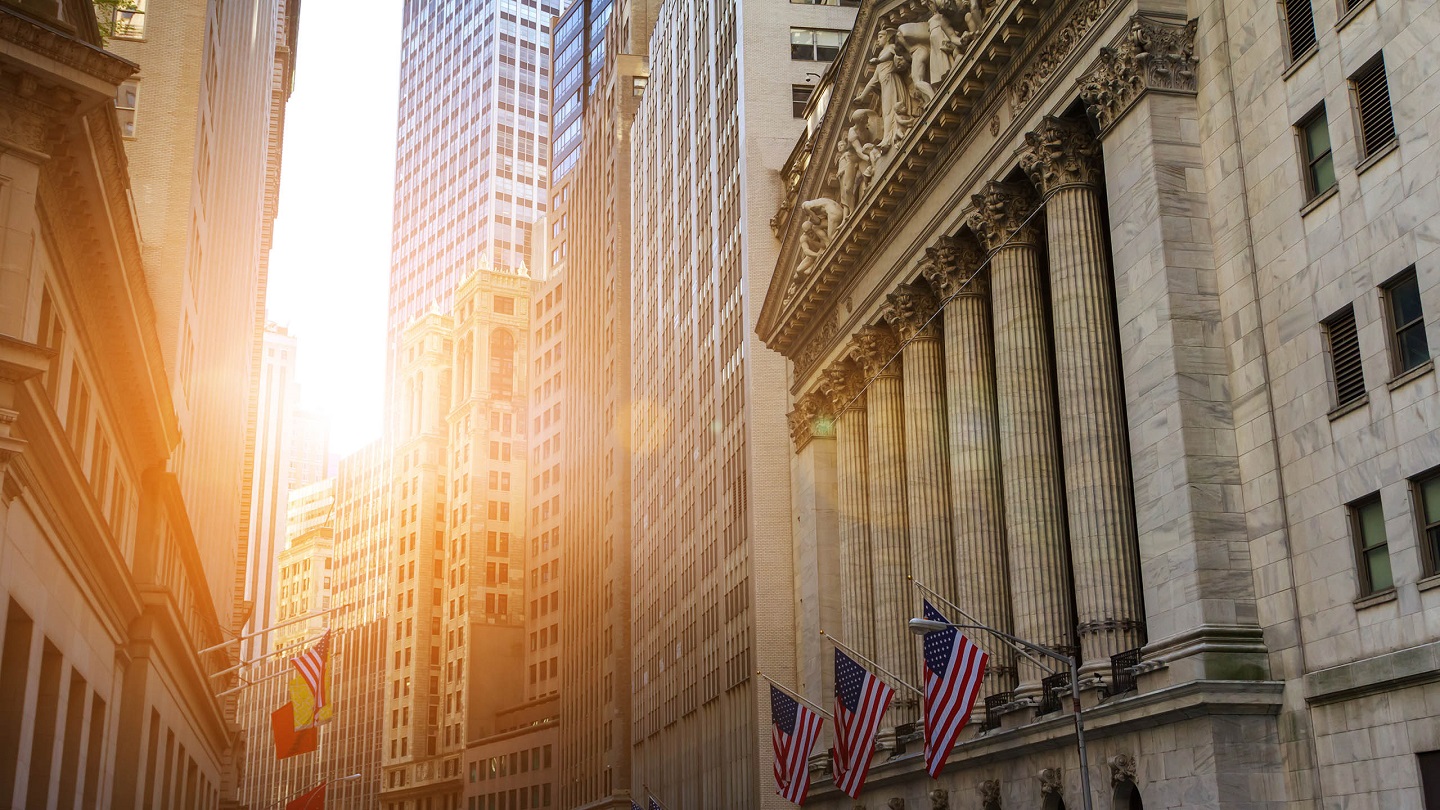 Sunlight shines on the historic buildings of the financial district in lower Manhattan, New York City near Wall Street