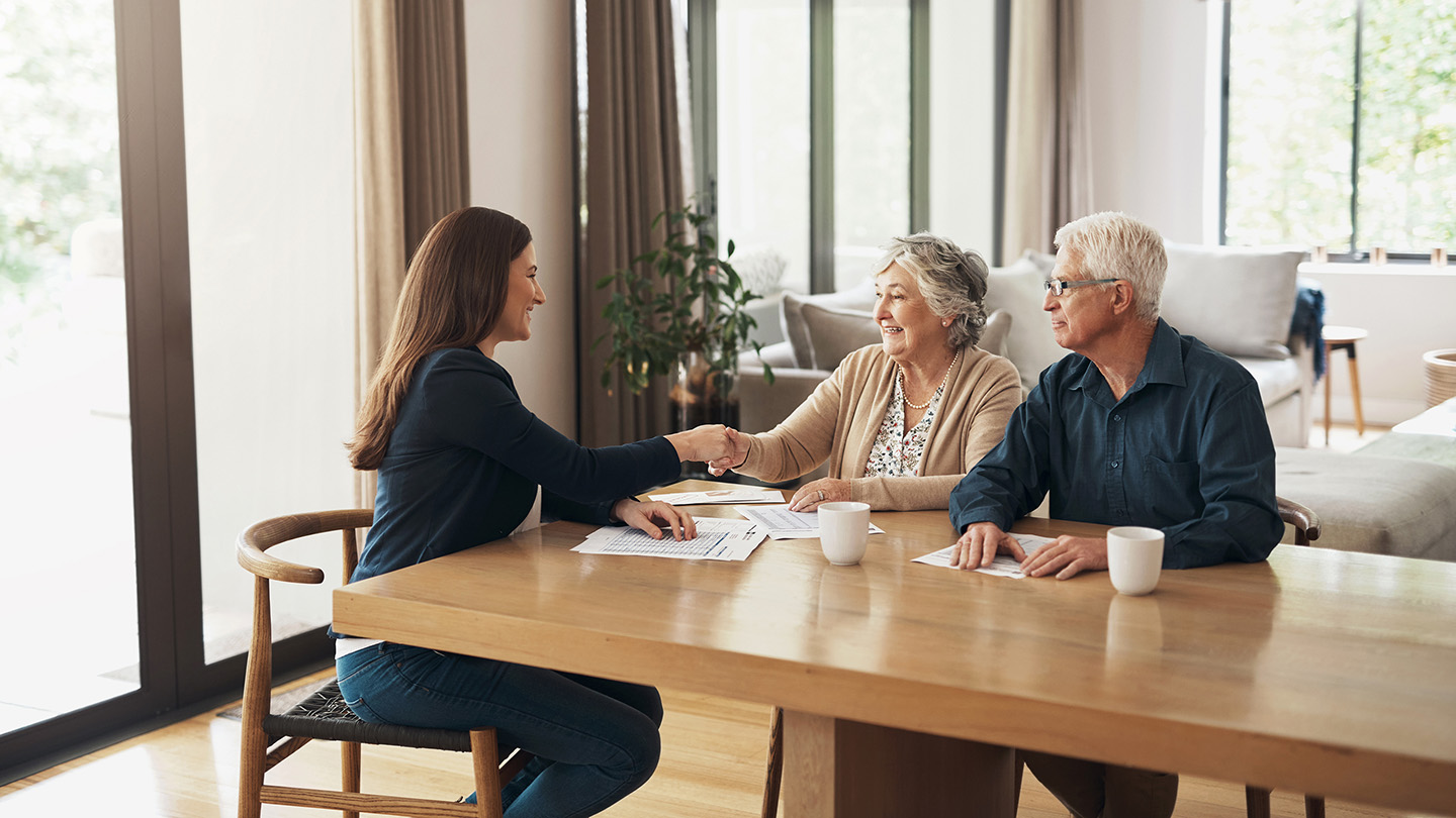 Handshake, broker or happy old couple consulting in meeting for retirement pension or tax bill advice. Financial advisor, elderly man or senior woman shaking hands for investment deal or savings plan